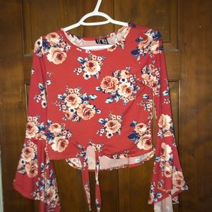 Floral top with tie front and bell sleeves.